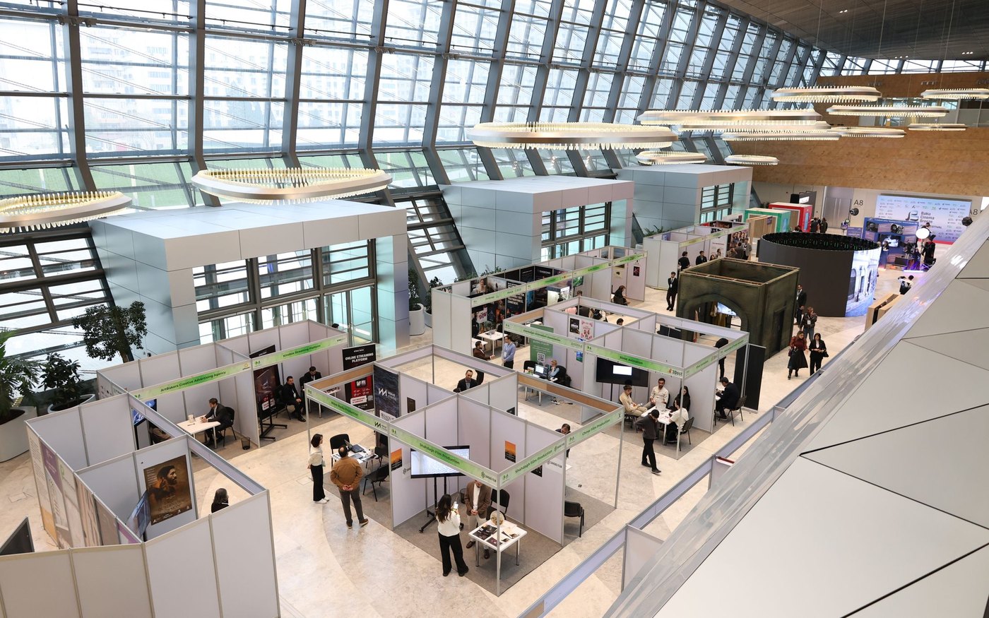 An exhibition hall with developer stands and buyers walking between them